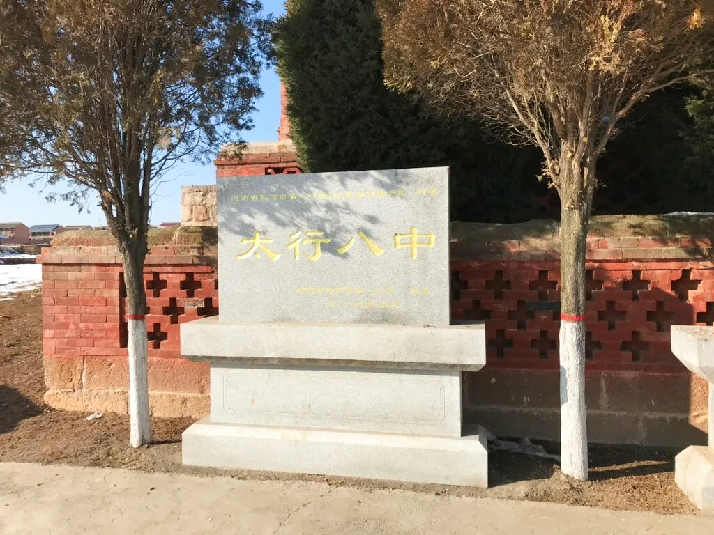 庙外的“太行八中”纪念碑，背后是带花格砖墙的高台